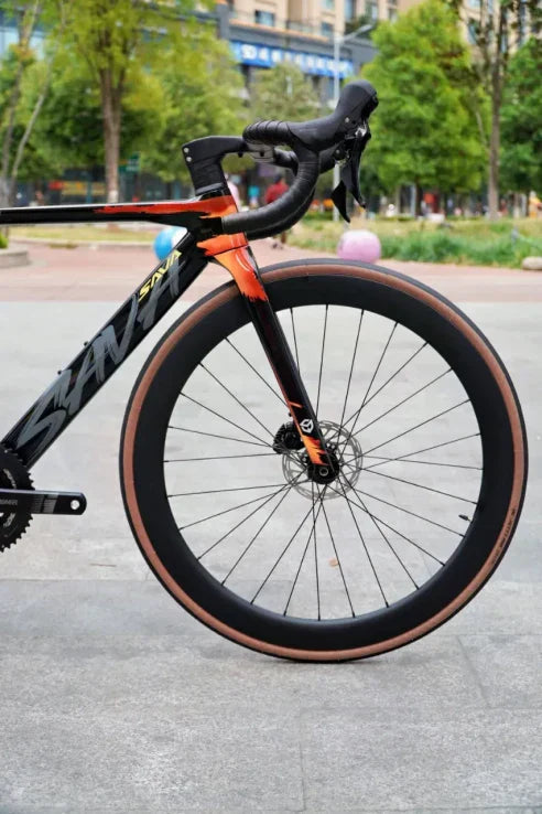 SAVA carbon road bike front wheel and handlebar outdoor close-up