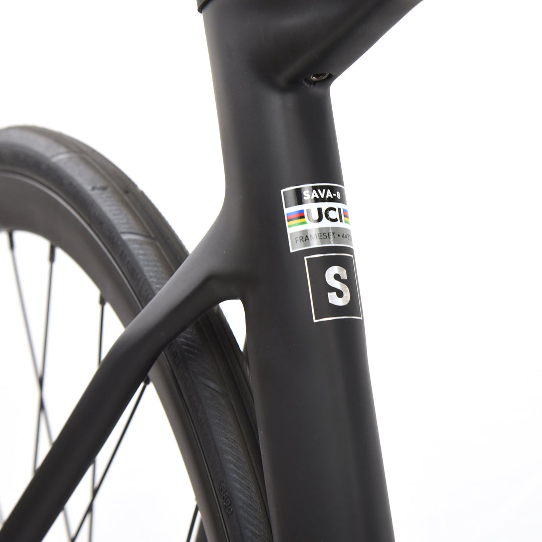 Close-up of SAVA Carbon road bike frame with UCI label and black tire