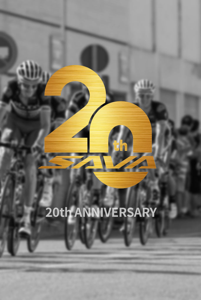 SAVA Carbon Bike 20th anniversary golden logo over cyclists racing on road bikes